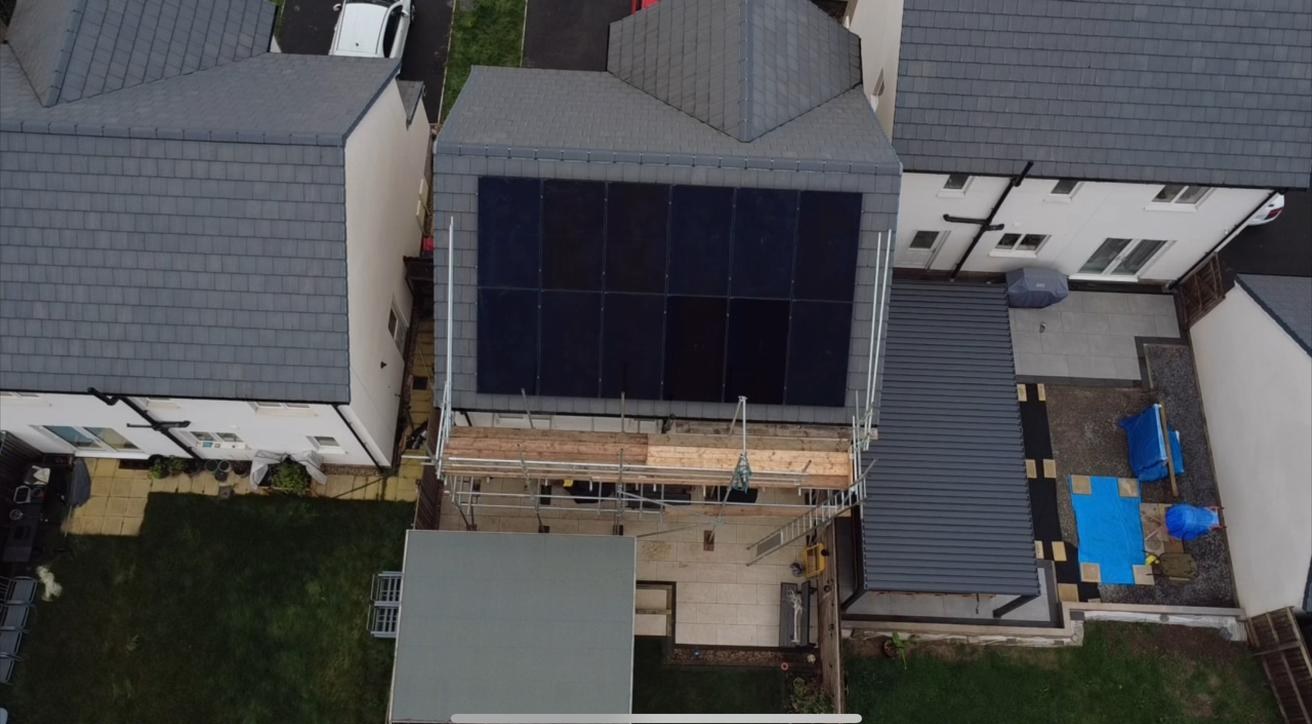 Aerial drone view of solar panels on a grey tiled roof